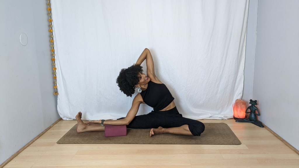 Head to knee pose resting forearm on block
